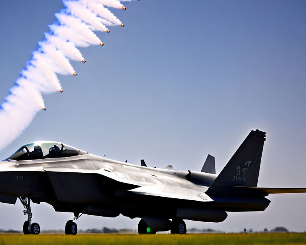 Fighter jet releasing flares on runway under clear blue sky