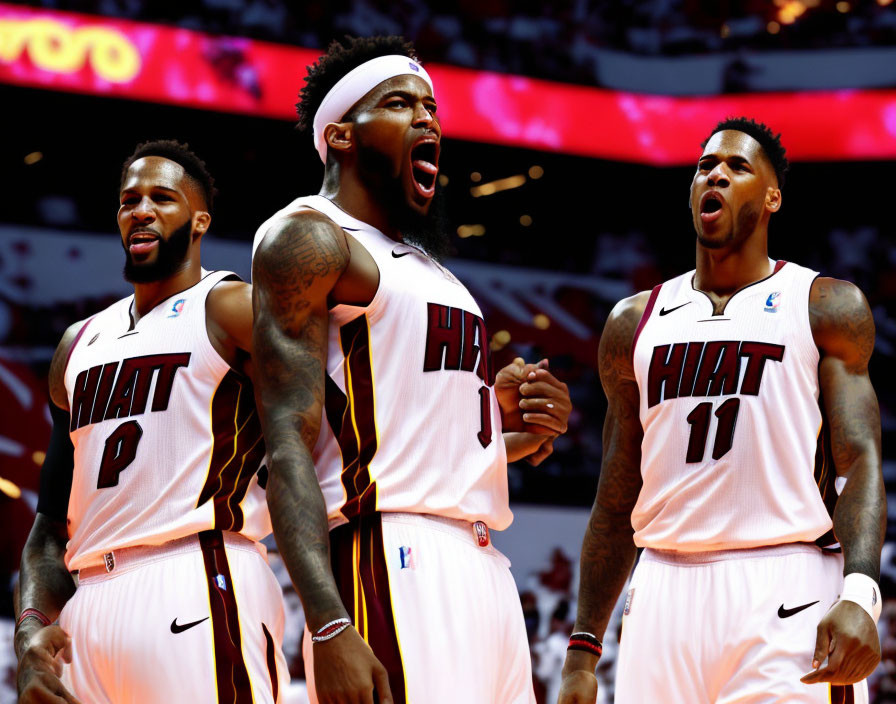 Miami Heat basketball players in white uniforms celebrating on court