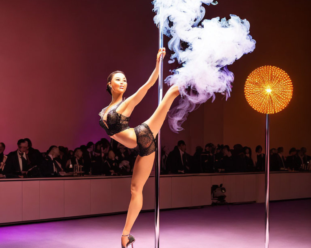 Performer in black outfit on pole with raised leg, amid smoke, warm lighting, audience.