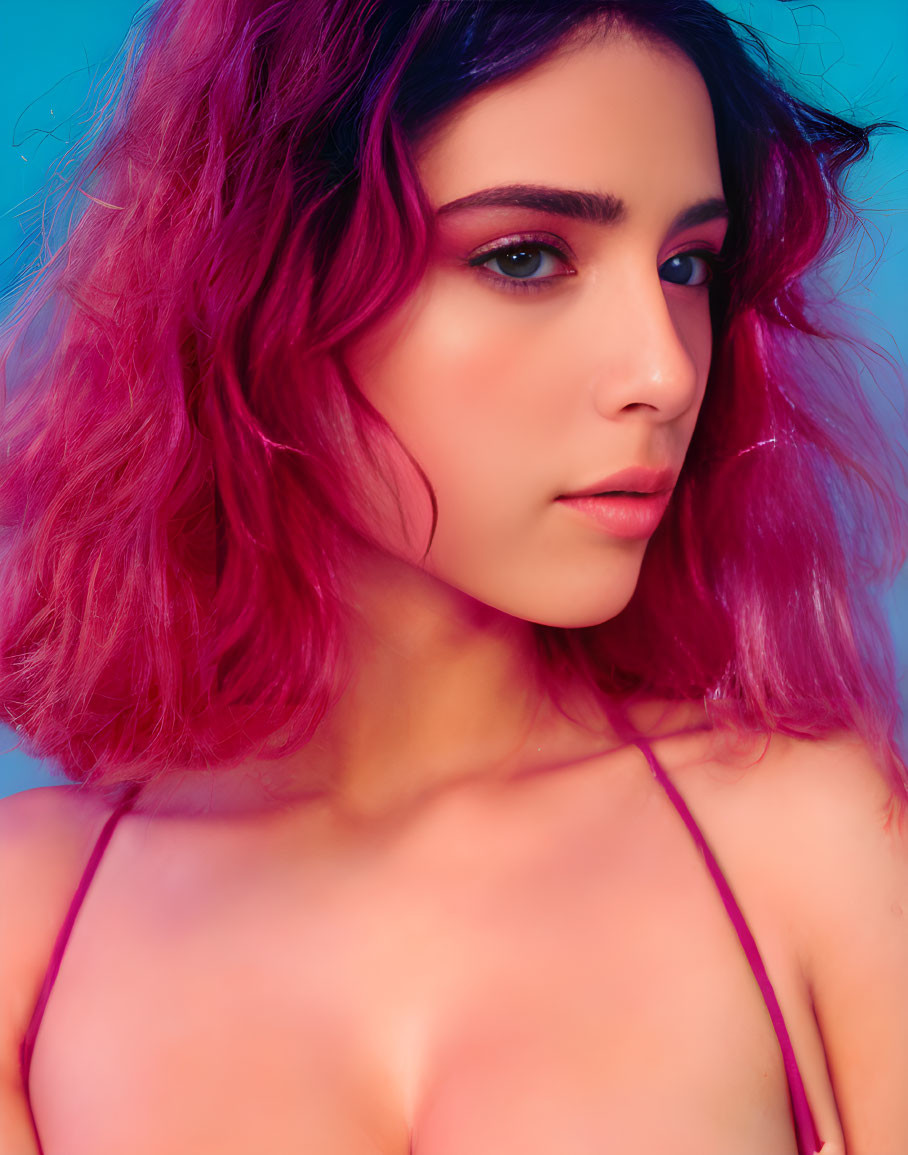 Person with Pink-Purple Hair and Makeup on Blue Background