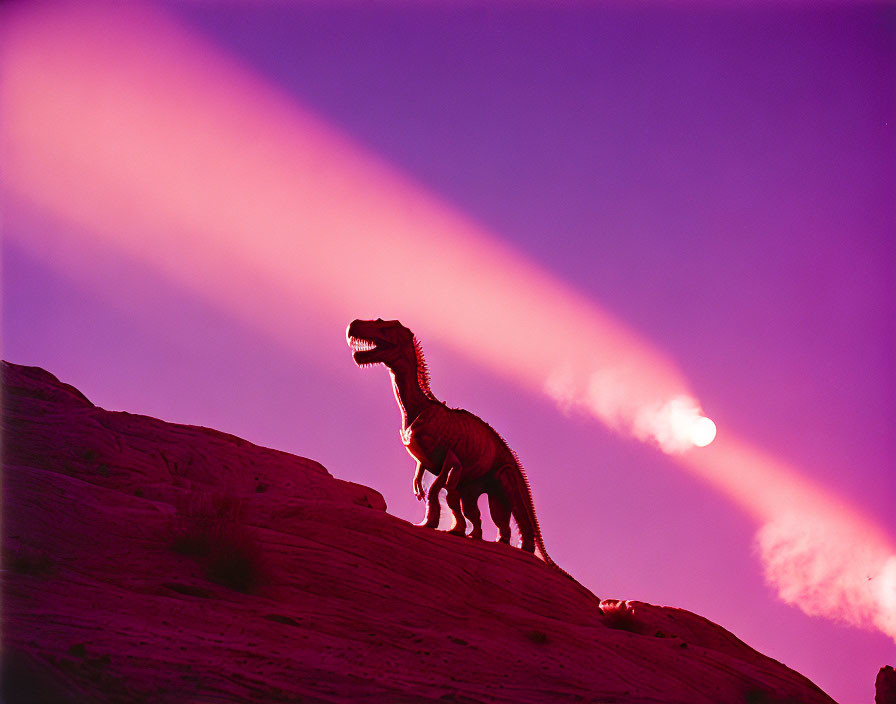 Dinosaur model silhouette on rocky hill under pink and purple sky