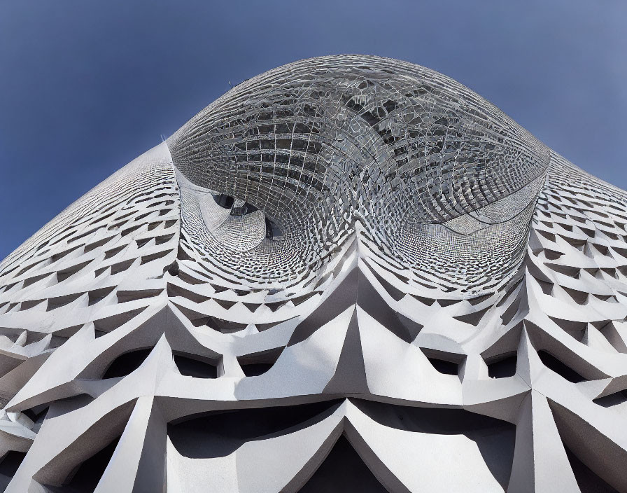 Modern Building with Geometric Facade and Honeycomb Pattern under Clear Blue Sky