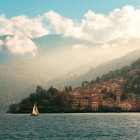 Traditional waterfront village nestled among hills at sunrise