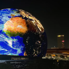 Surreal image of Earth above city skyline at night