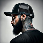 Bearded man with neck tattoos in snapback cap