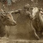 Detailed Sandstone Relief Carving of Three Bulls