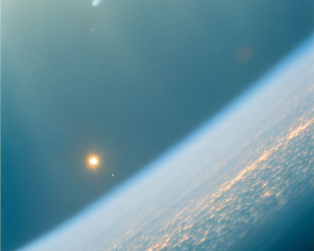 Sunlight creating lens flare over Earth's curved horizon with city lights below