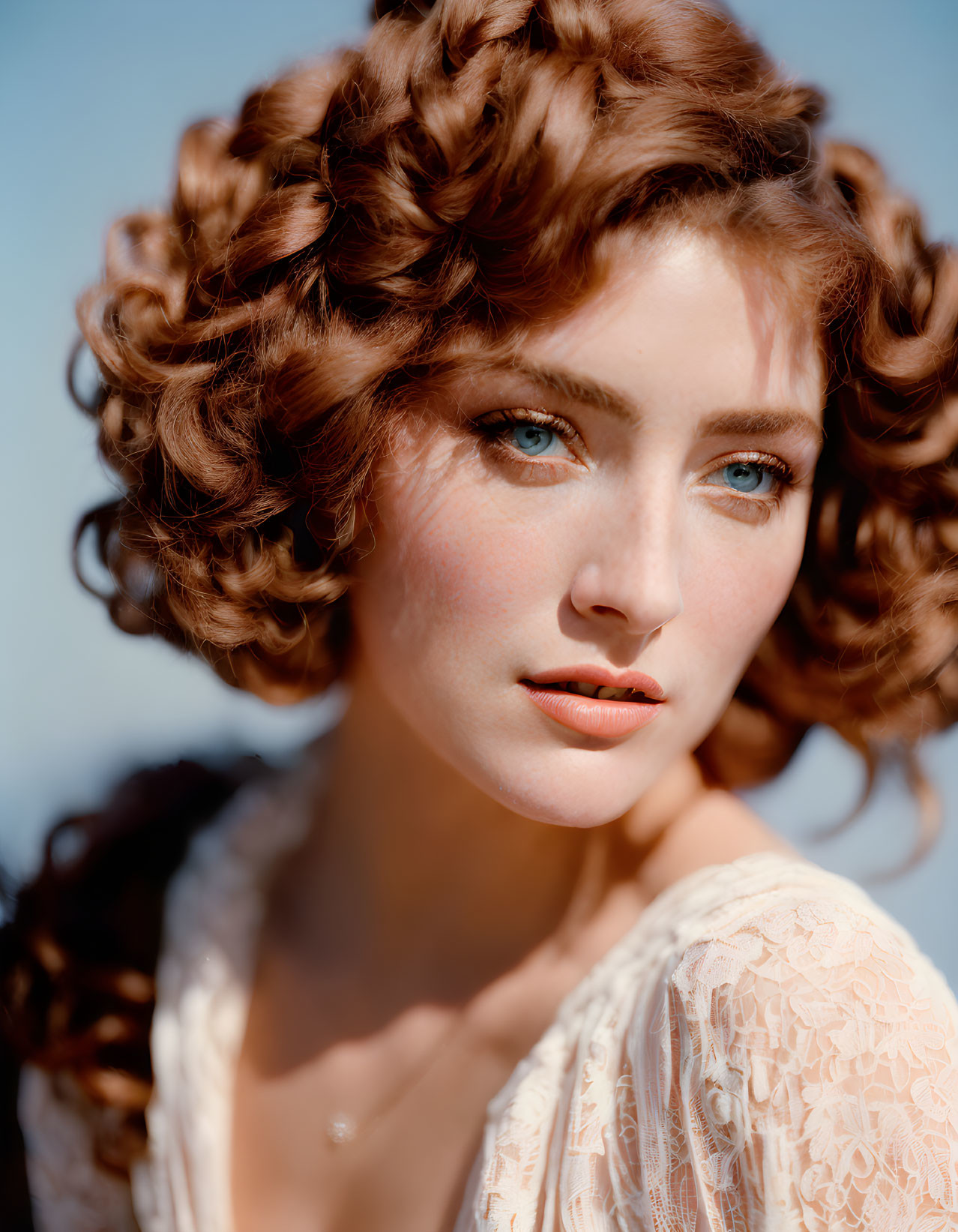 Portrait of woman with curly brown hair, blue eyes, fair skin, white lace garment, soft blue