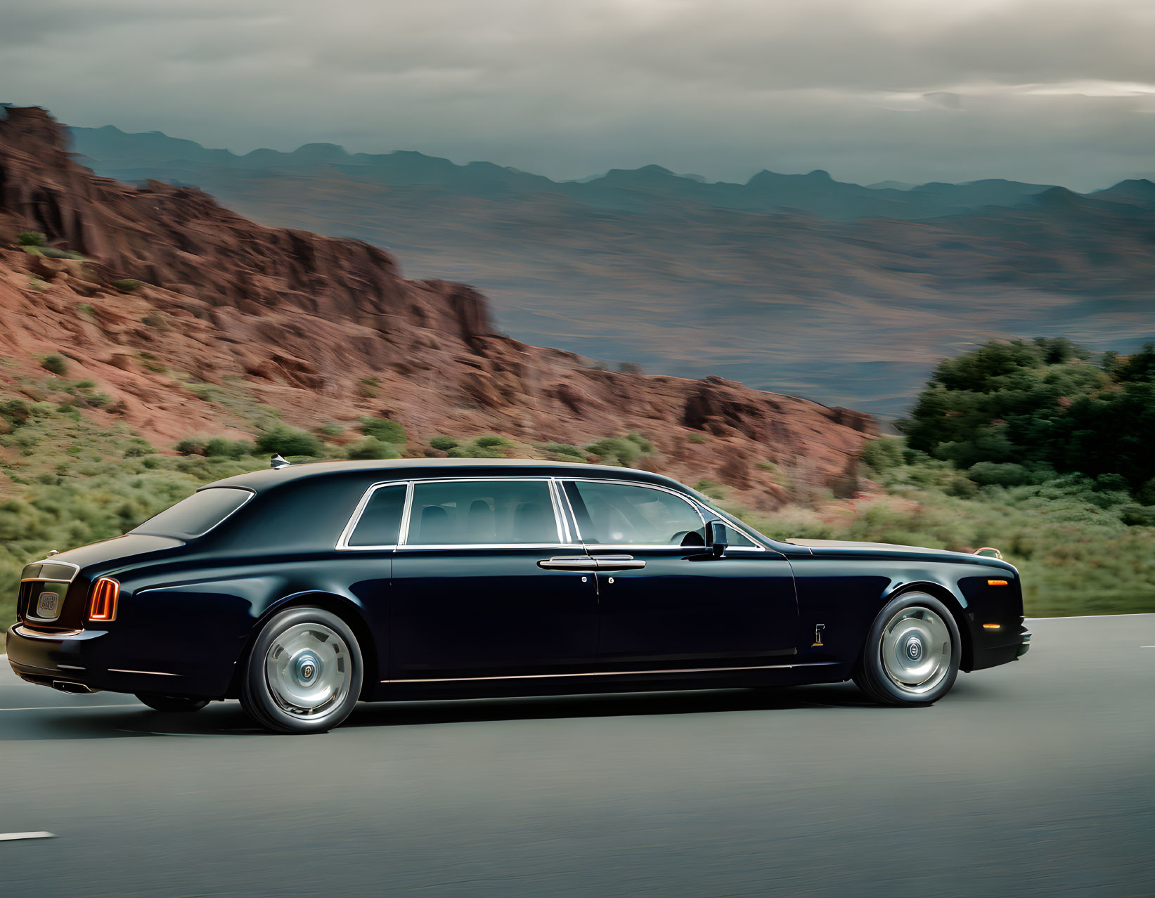 Luxurious black sedan driving through mountainous desert landscape