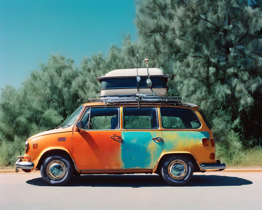 Vintage multicolored van with surfboards parked by roadside and trees in background