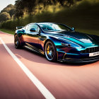 Sleek metallic blue sports car on road with green hedges