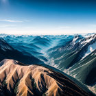 Snowy Peaks and Shadowy Valleys: Aerial View of Layered Mountain Ranges