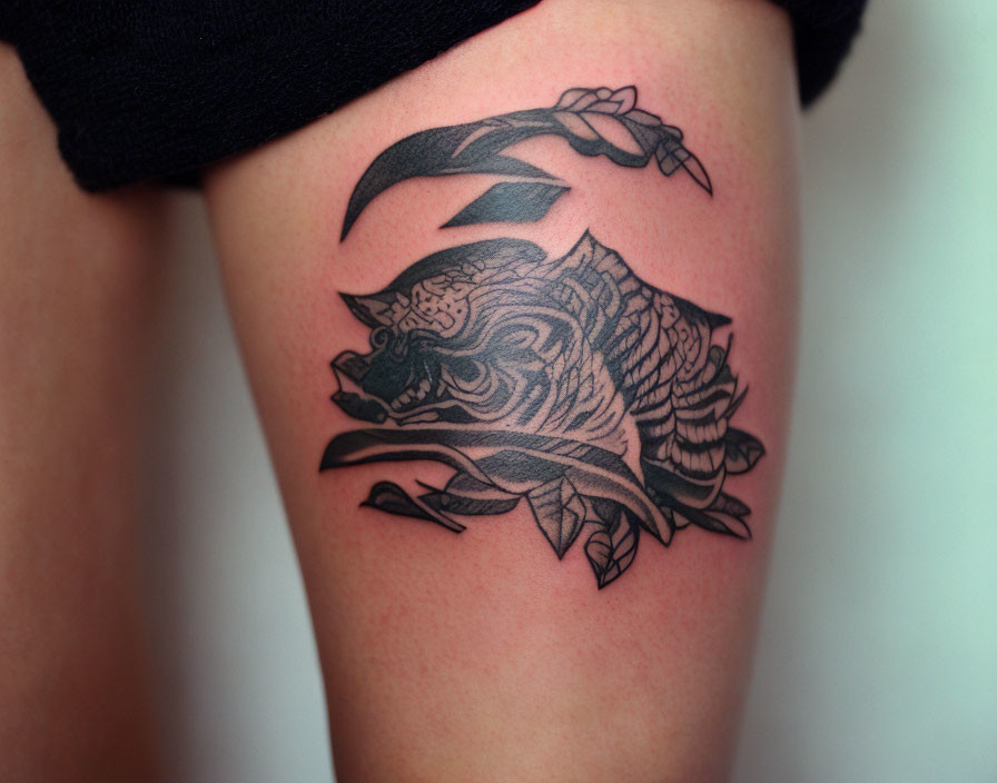 Black and Gray Tiger Head Tattoo with Floral Elements on Upper Arm