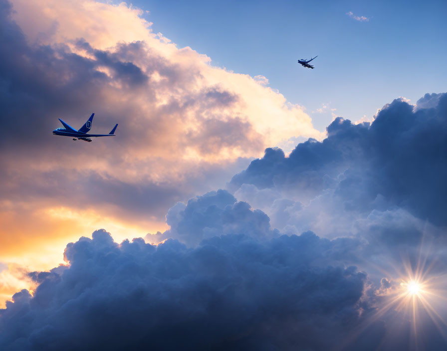 Airplanes flying at different altitudes against dramatic clouds and radiant sunset