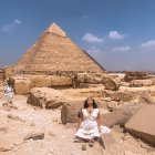 Iconic Great Pyramids of Giza in Egypt with clear blue sky and surrounding desert landscape.