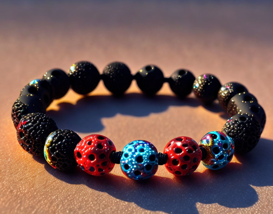 Handmade Beaded Bracelet with Black, Red, and Blue Lava Style Beads