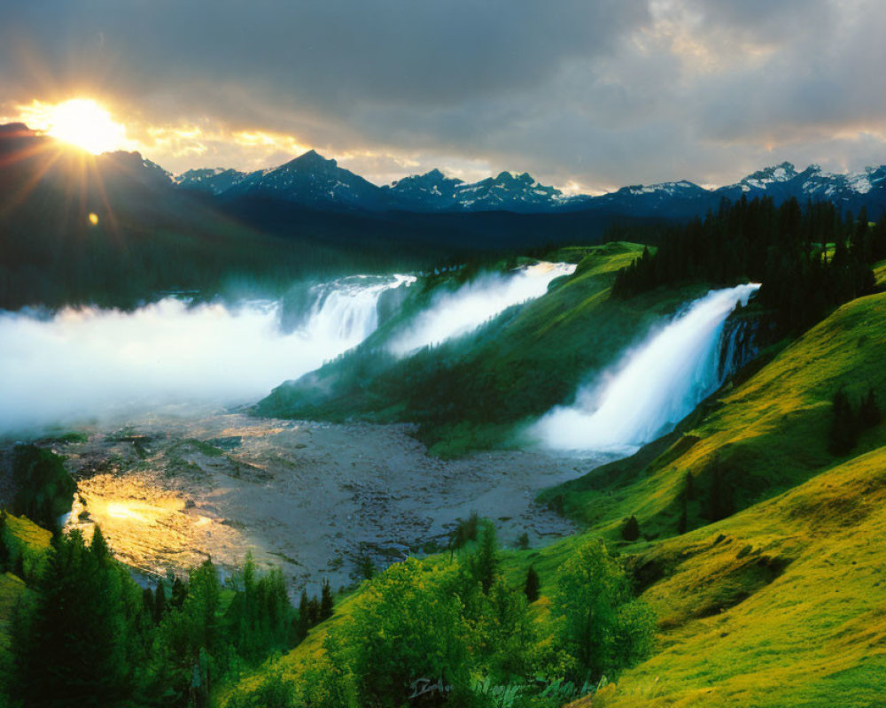 Scenic sunset view of majestic waterfall, mist, grassy slopes, and mountains.