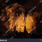 Mysterious Cave with Rocky Formations and Small Fires