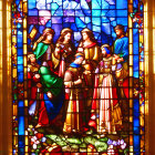 Colorful stained glass window depicting richly robed figures in a golden interior