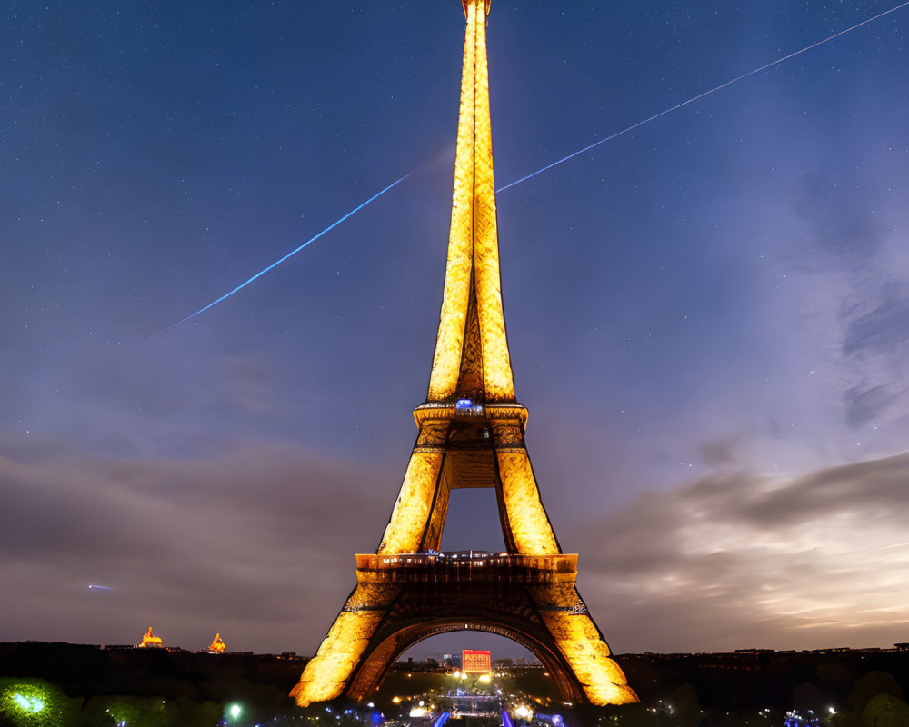 Iconic Eiffel Tower Night View with Passing Aircraft Streaks