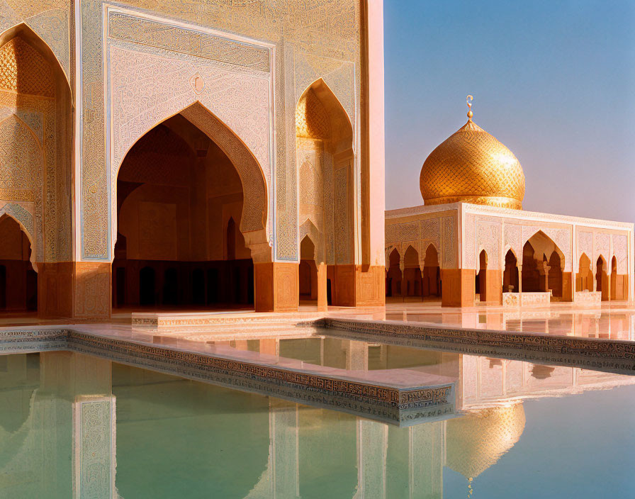 Golden dome mosque with ornate archways reflected in water pond at sunset