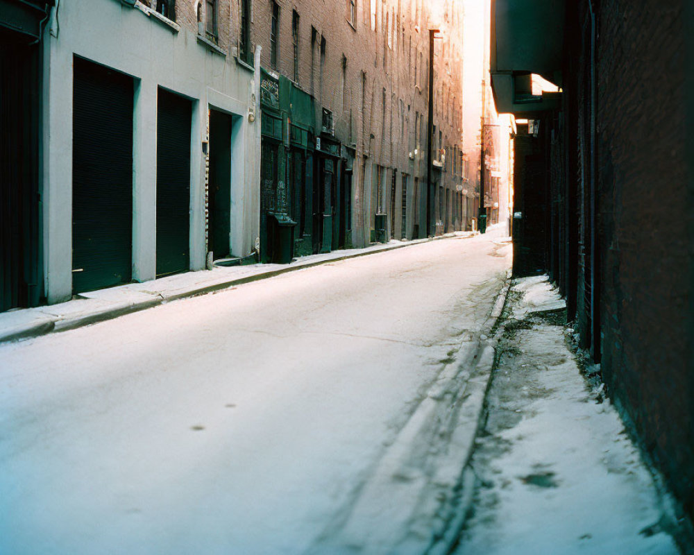 Winter scene: Snowy alley, buildings, glowing light.