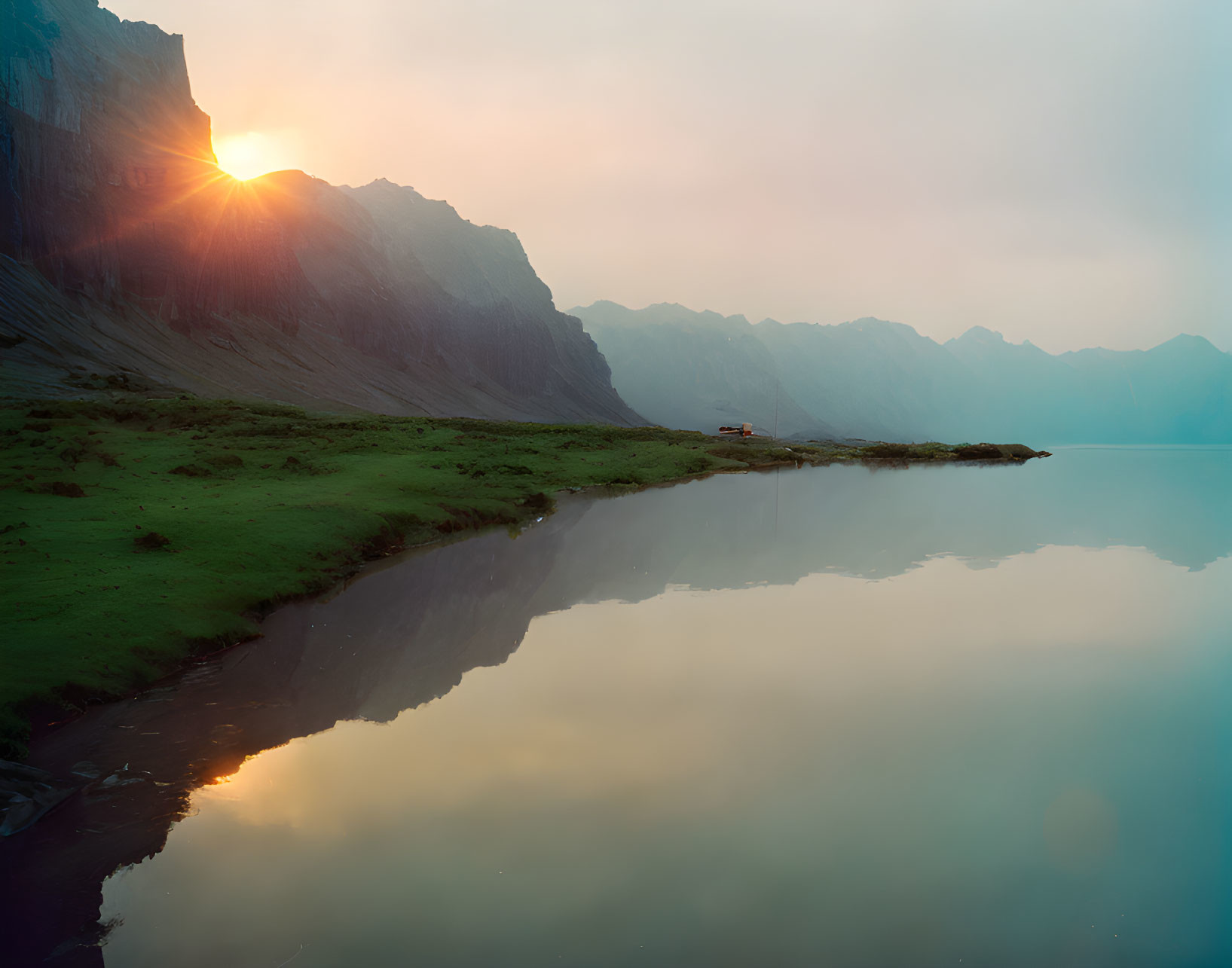 Tranquil sunrise scene: lake, mountains, clear reflections