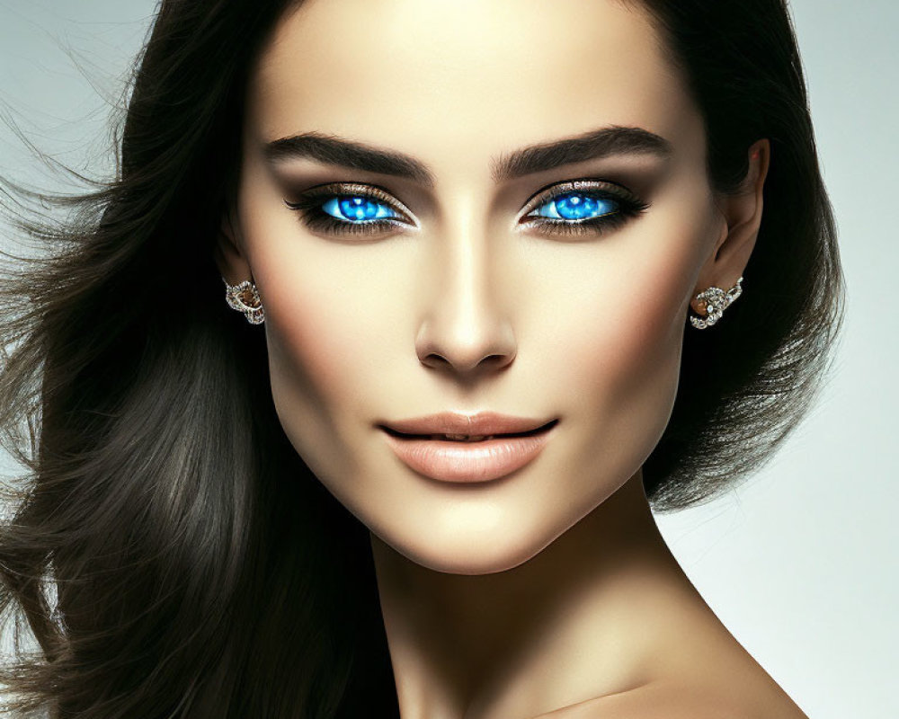 Portrait of woman with blue eyes, flawless skin, glossy brown hair, diamond earrings