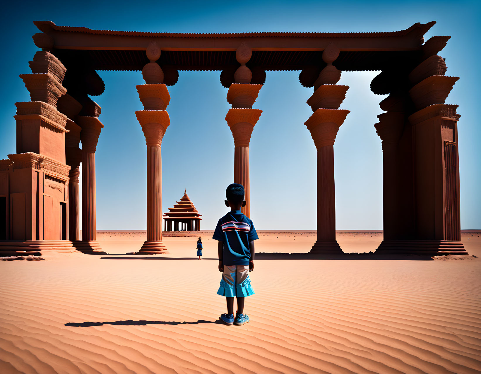 Boy standing in sandy desert near ancient temple gateway