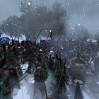 Armored medieval soldiers marching in snowy forest landscape