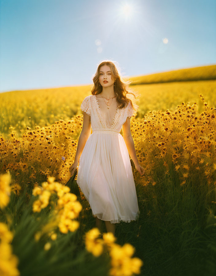 Woman in white dress in sunflower field under clear blue sky