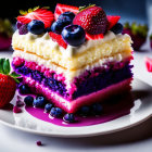 Colorful layered cake topped with whipped cream and fresh berries on a white plate