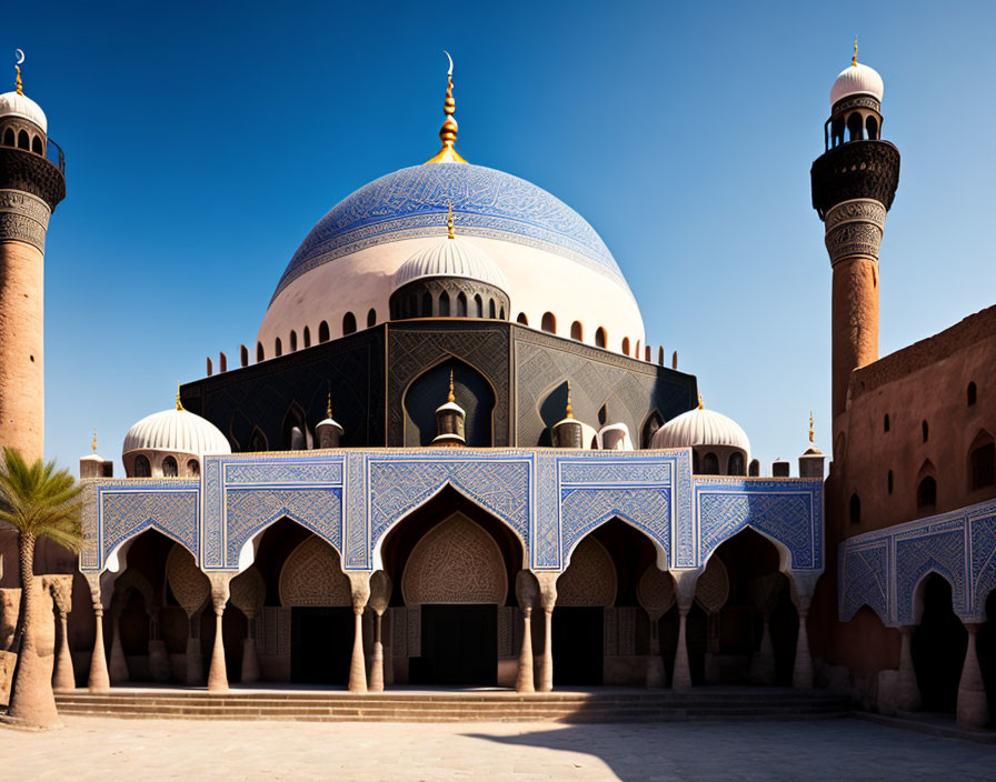 Blue-domed mosque with intricate patterns and minarets under clear sky