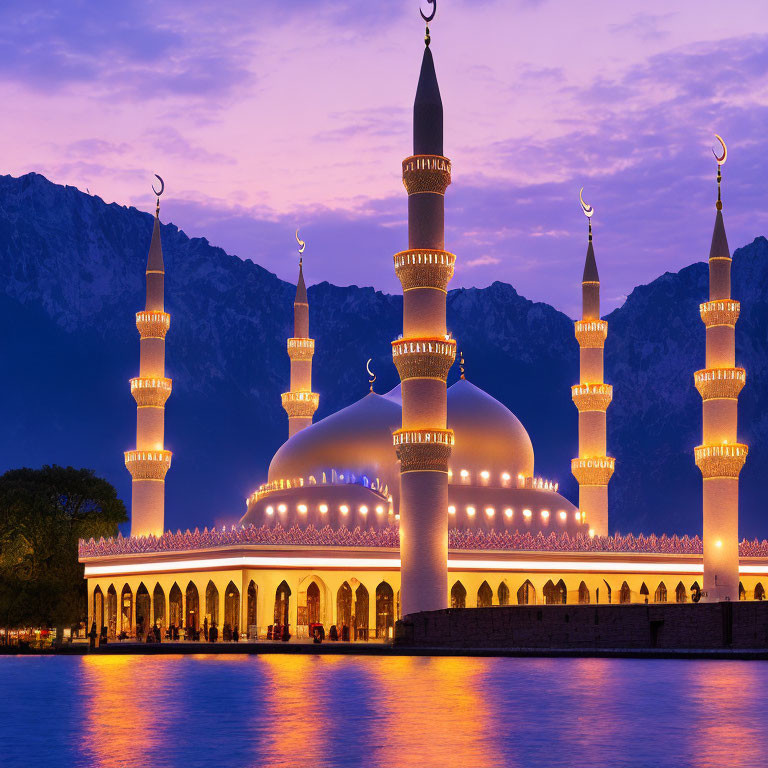 Illuminated mosque with minarets against mountain backdrop at dusk