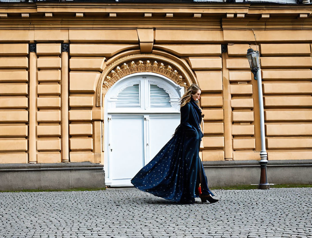 Woman in Blue Star-Patterned Dress Passing Historic Building
