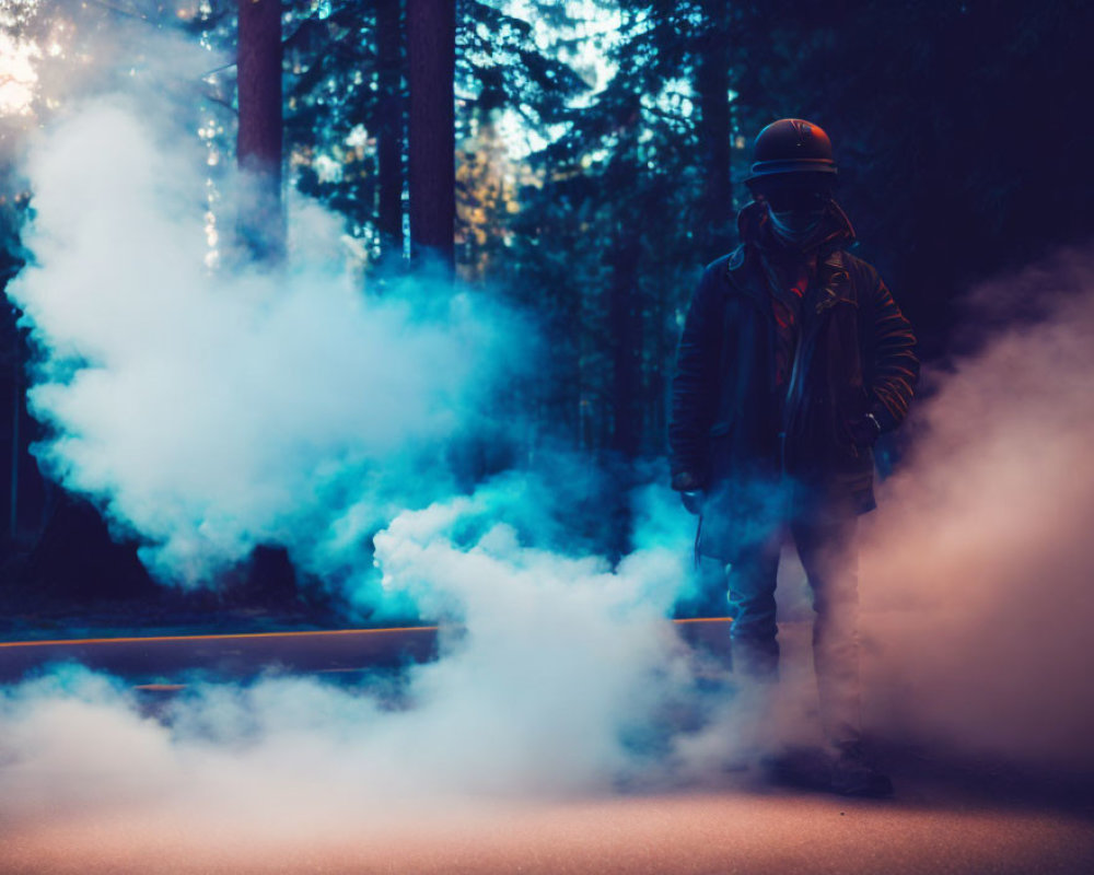 Person in protective gear surrounded by blue smoke on forest path