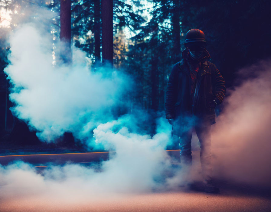 Person in protective gear surrounded by blue smoke on forest path