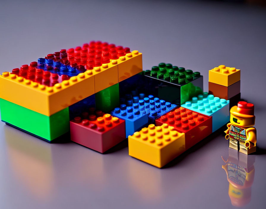 Vibrant Lego Bricks Structure with Figure on Reflective Surface