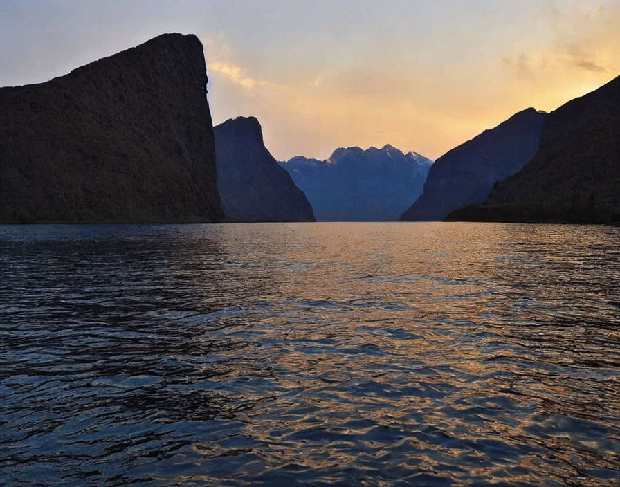 Tranquil Lake Sunset with Silhouetted Mountains