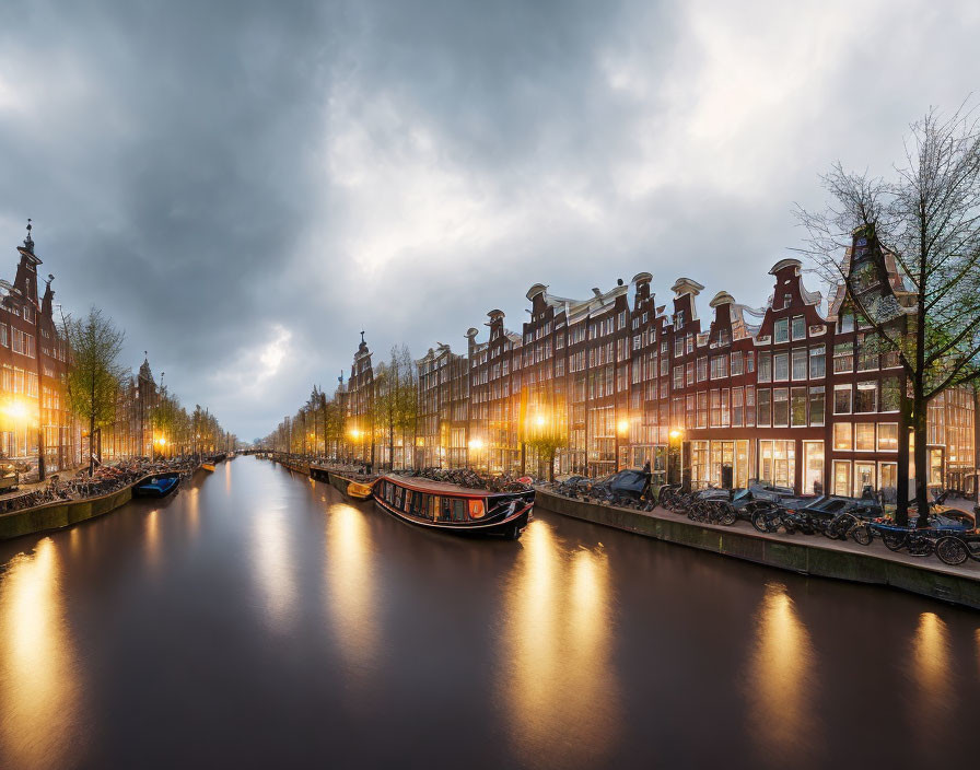 Amsterdam canal at twilight with Dutch buildings and bicycles