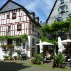 Charming European village street with half-timbered houses and outdoor dining