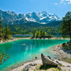 Tranquil lake landscape with canoe, mountains, and cabin