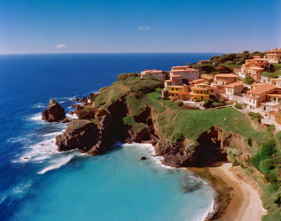 Terracotta-roofed buildings in coastal resort town overlooking serene bay