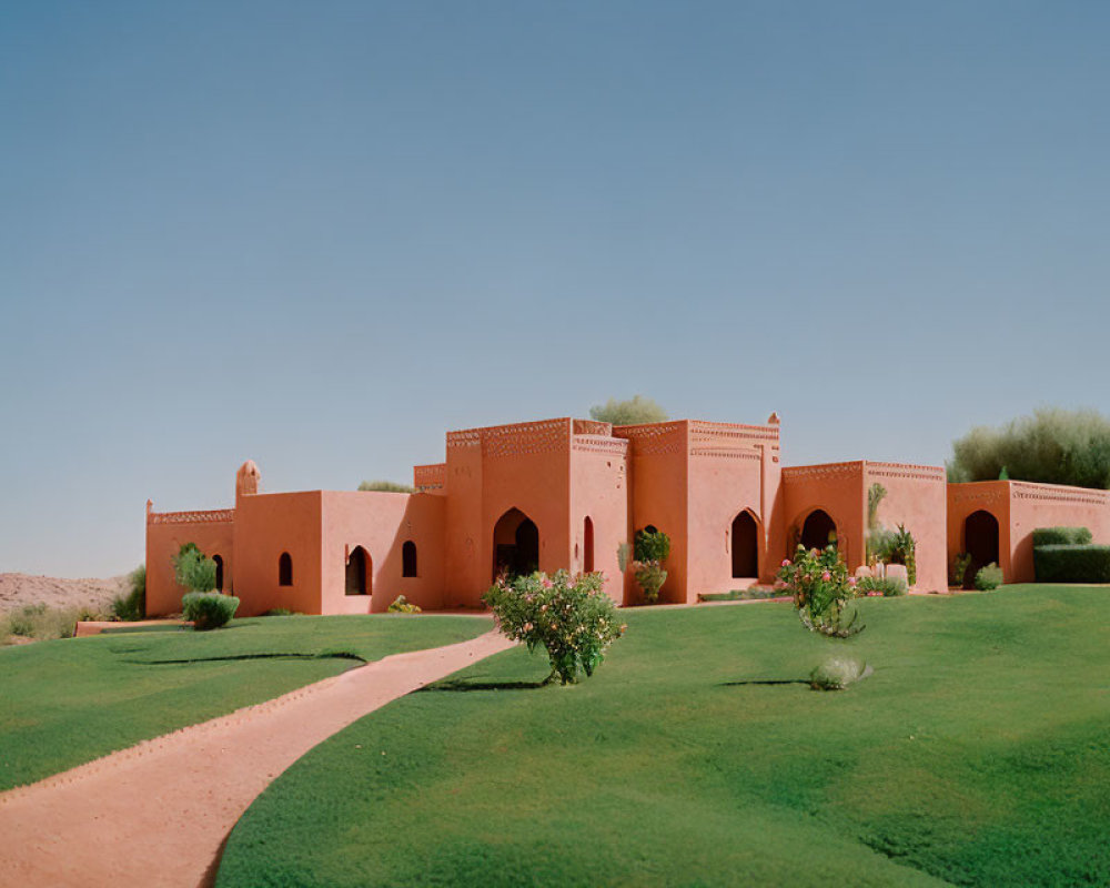 Desert landscape with terracotta buildings and arches