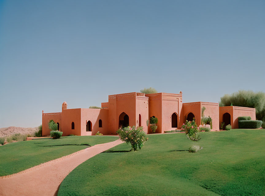 Desert landscape with terracotta buildings and arches