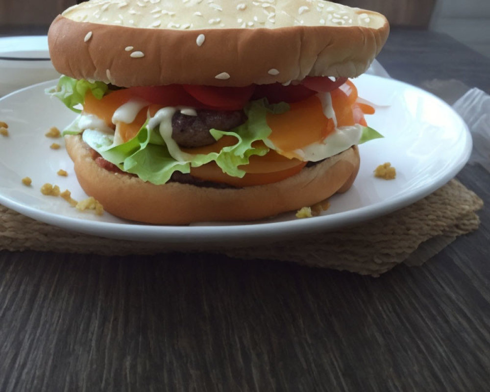 Classic Cheeseburger with Lettuce, Tomato, Onions, and Condiments on Sesame Seed