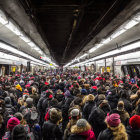 Crowded Subway Train with Passengers in Winter Clothing