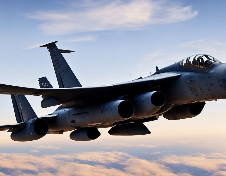 Military fighter jet with multiple engines soaring above clouds at sunrise/sunset.