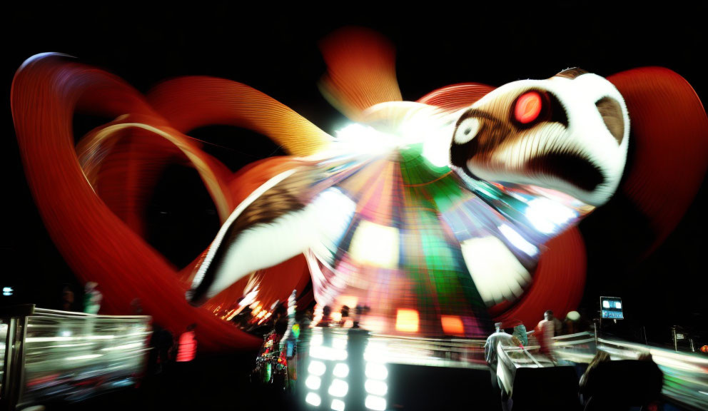 Colorful fairground ride light trails in night sky with blurred figures