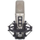 Silver condenser microphone with mesh top, logo, knobs, switches, and shock mount